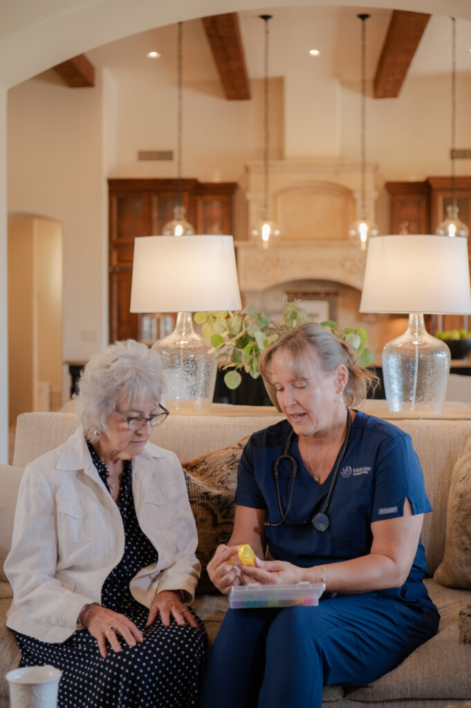 Caregiver helping senior client with medication management.