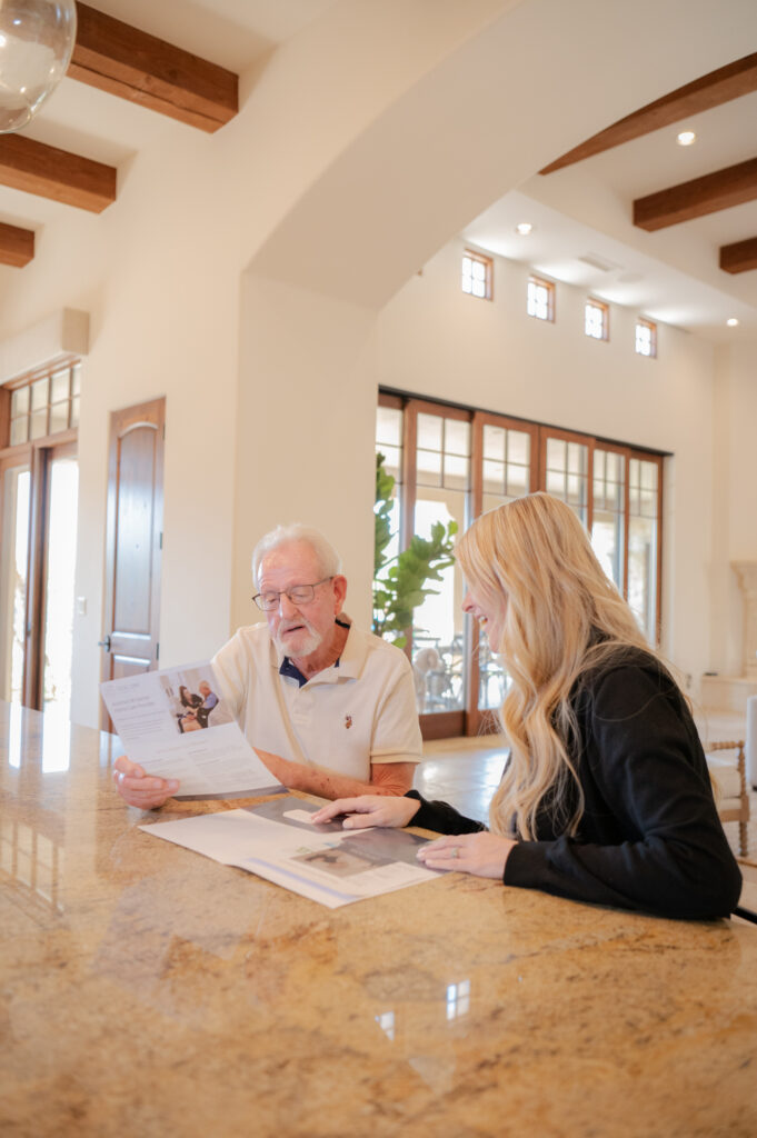 Care manager patiently explaining a care plan to a senior client at home.