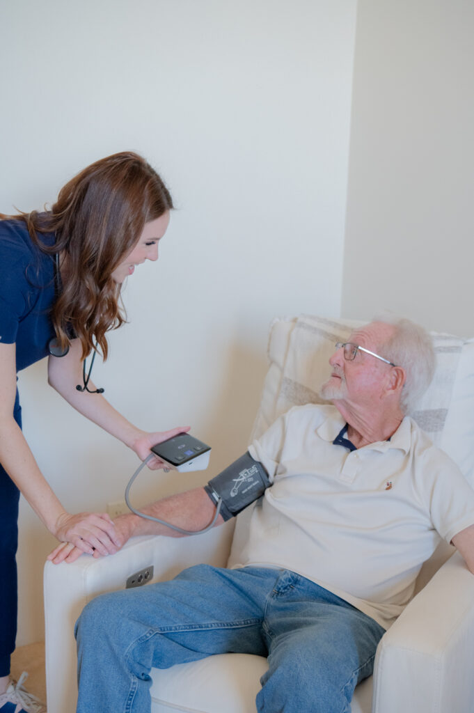 Caregiver checking the blood pressure of a senior client.